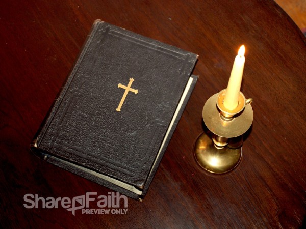 Holy Bible and Lit Candle