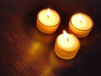 Three%20Lit%20Candles%20on%20Wood