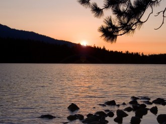 Sun Setting over Forest and Waters
