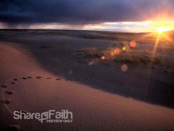 Footprints in Sand at Sunset