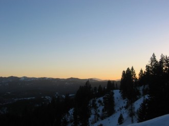 Sun%20Setting%20Behind%20Snowy%20Pines