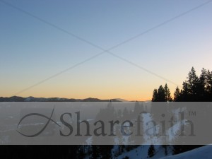 Sun%20Setting%20Behind%20Snowy%20Pines