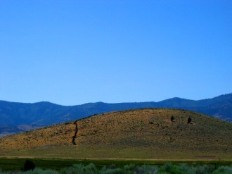 Hill with Blue Sky and Mountains